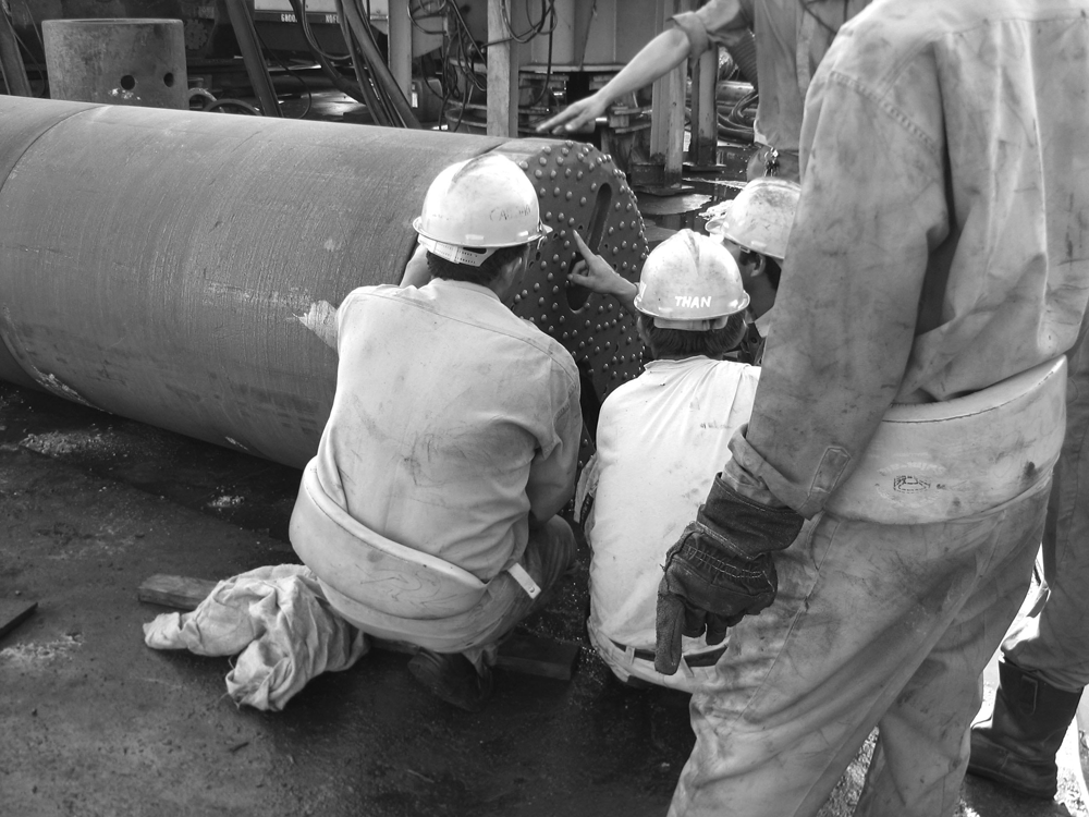 Drillings inspecting an Reverse Circulation Bit and RC DHH on the job